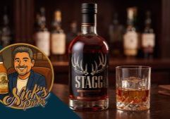 A bottle of Stagg whiskey and a glass of whiskey with ice sit on a bar, with a cartoon logo reading "Nick's Picks" in the corner.